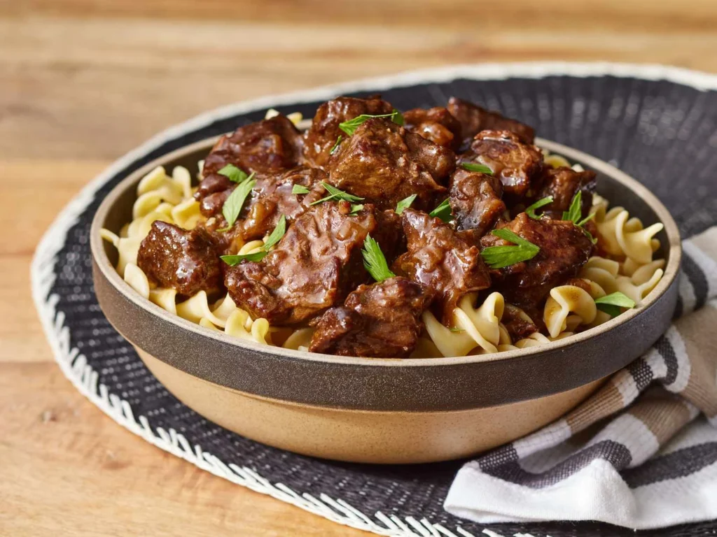 Tender beef tips with brown gravy over egg noodles