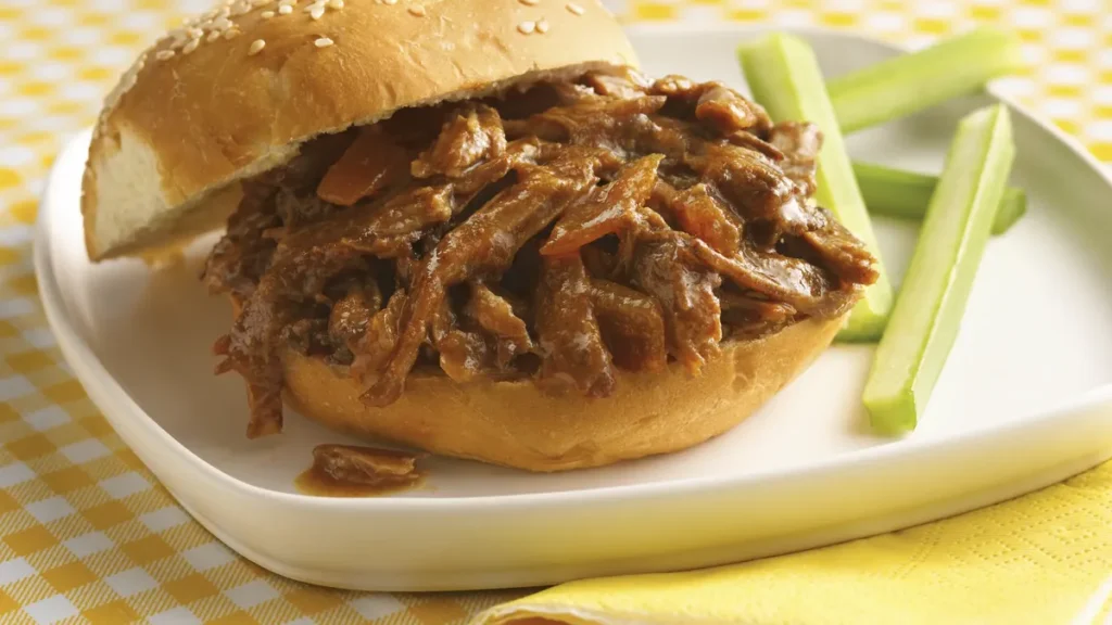 slow cooker shredded beef sandwich on soft bun