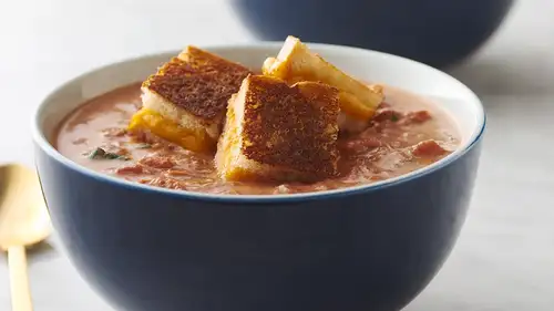 slow cooker beef vegetable soup served with bread and grilled cheese