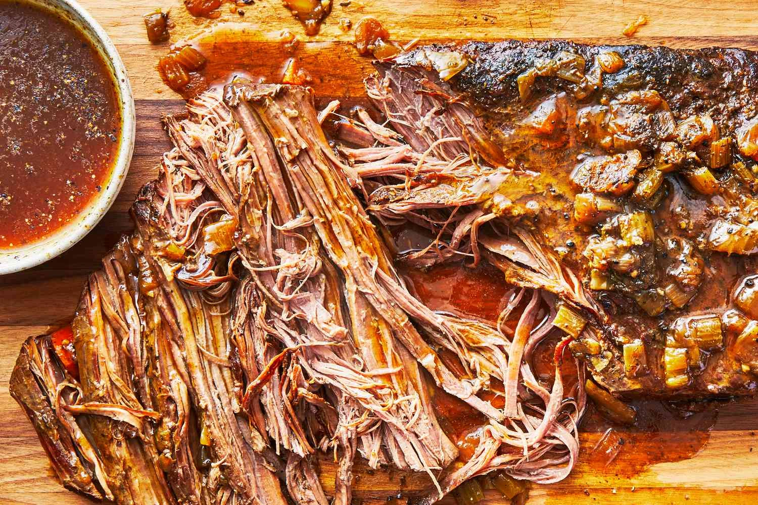 tender slow cooker beef brisket sliced against the grain with barbecue sauce