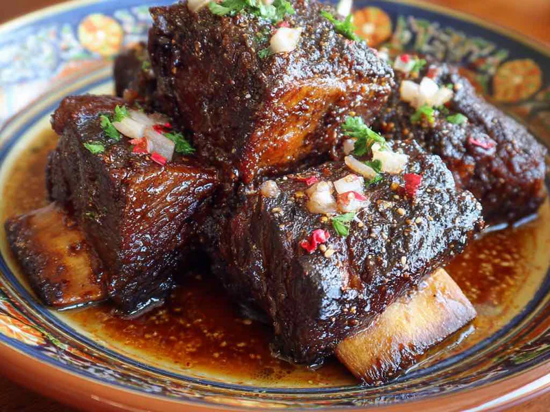Slow cooker beef short ribs tested with a fork showing tender meat.