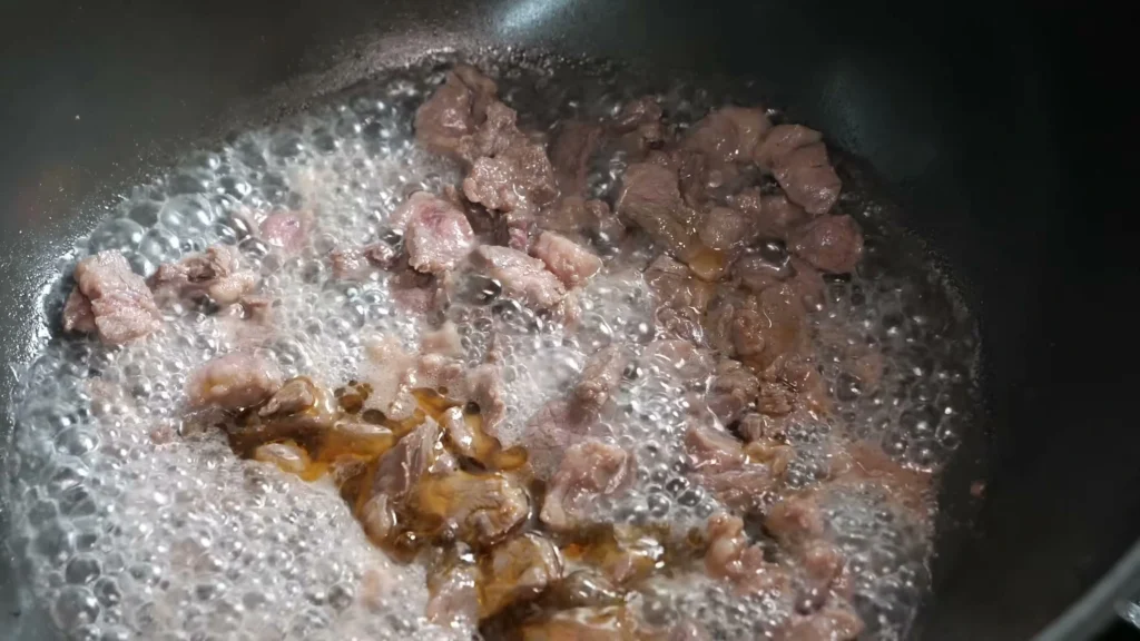 beef tips browning in a skillet to build flavor before simmering in gravy