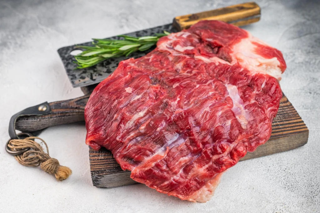 Lean round roast cut of beef displayed on a cutting board for pot roast preparation